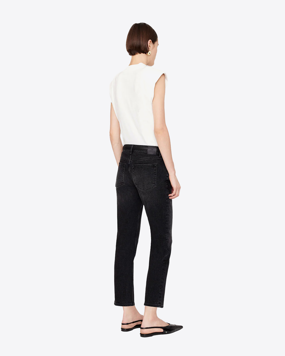 Jean taille basse Skinny toile noire délavée extensible Nix Anine Bing. Porté de profil dos.